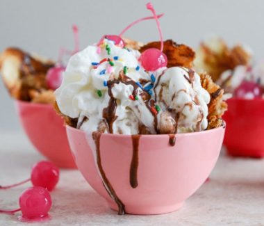 Velvet Crust Bakery in Jaora serving a rich chocolate ice cream sundae with fresh toppings.